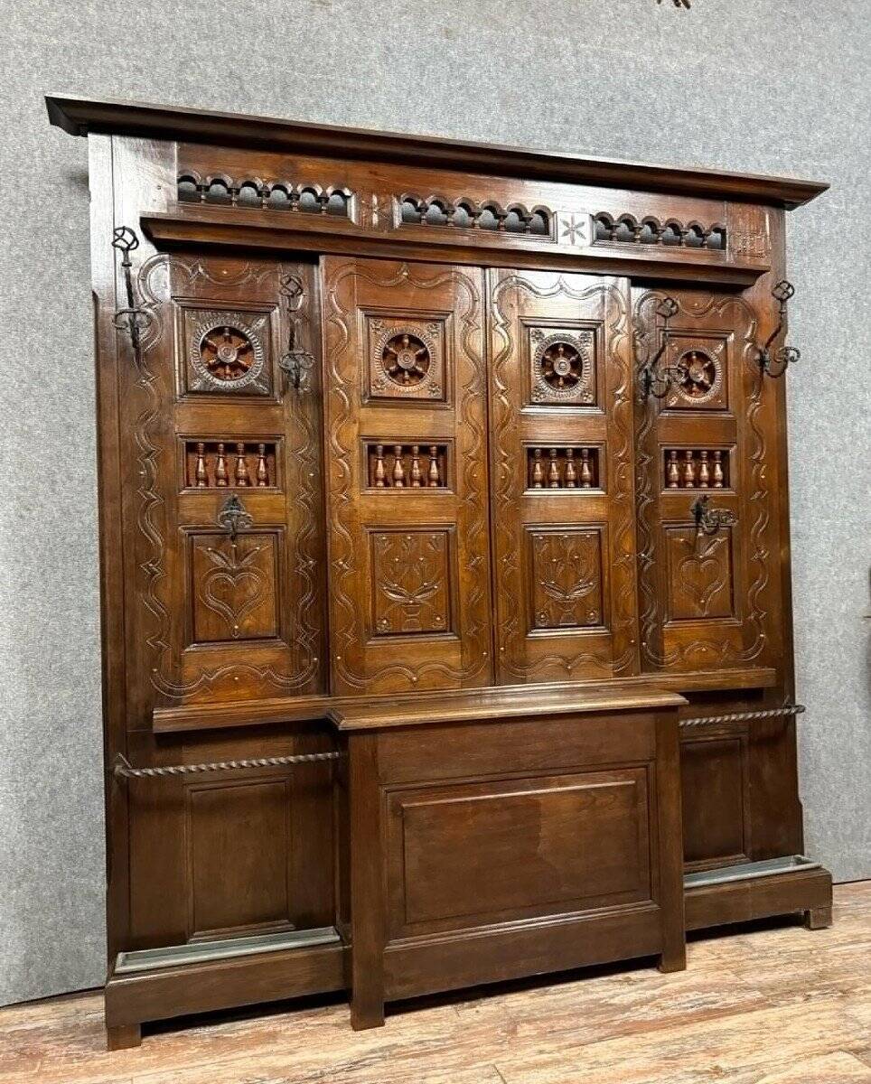 Important neo-Gothic entrance wardrobe in carved oak with chest.