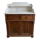 Antique wooden chest of drawers with a marble top.