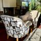 Pair of beige bouclette fabric frog chairs and their footrest.