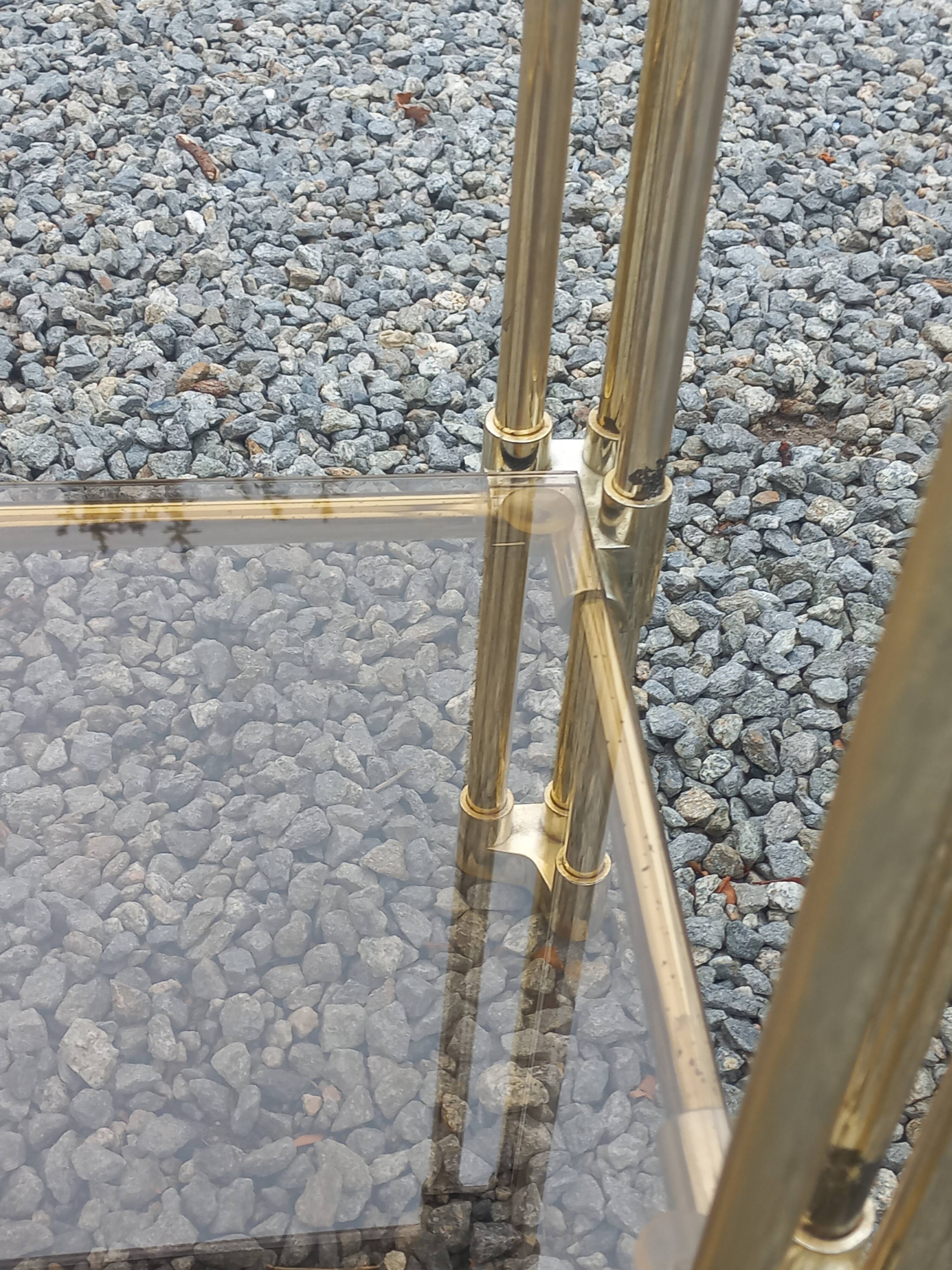 Pair of Hollywood Regency side tables in gold metal and smoked glass.