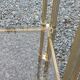 Pair of Hollywood Regency side tables in gold metal and smoked glass.