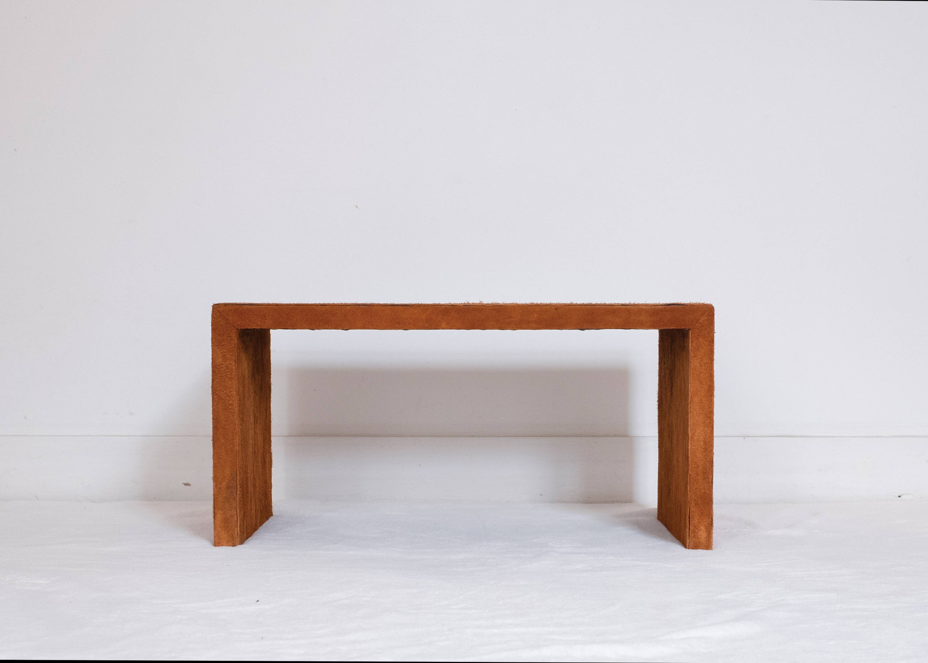 Pair of cognac suede side tables in the style of Jean Michel Frank.