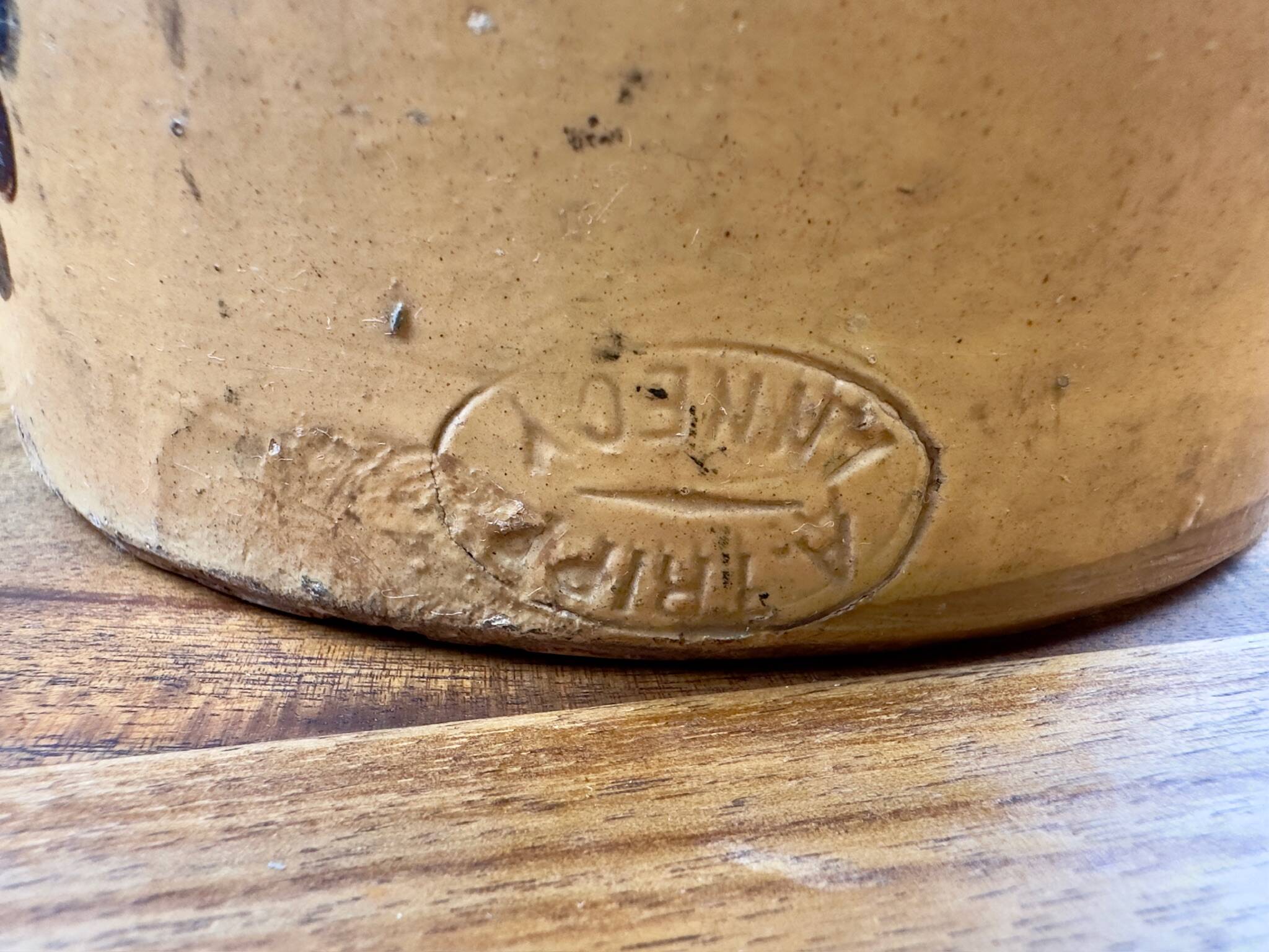 Large vintage ceramic pitcher with abstract green and brown decoration.