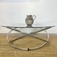 Coffee table with glass top and chrome tubular base
