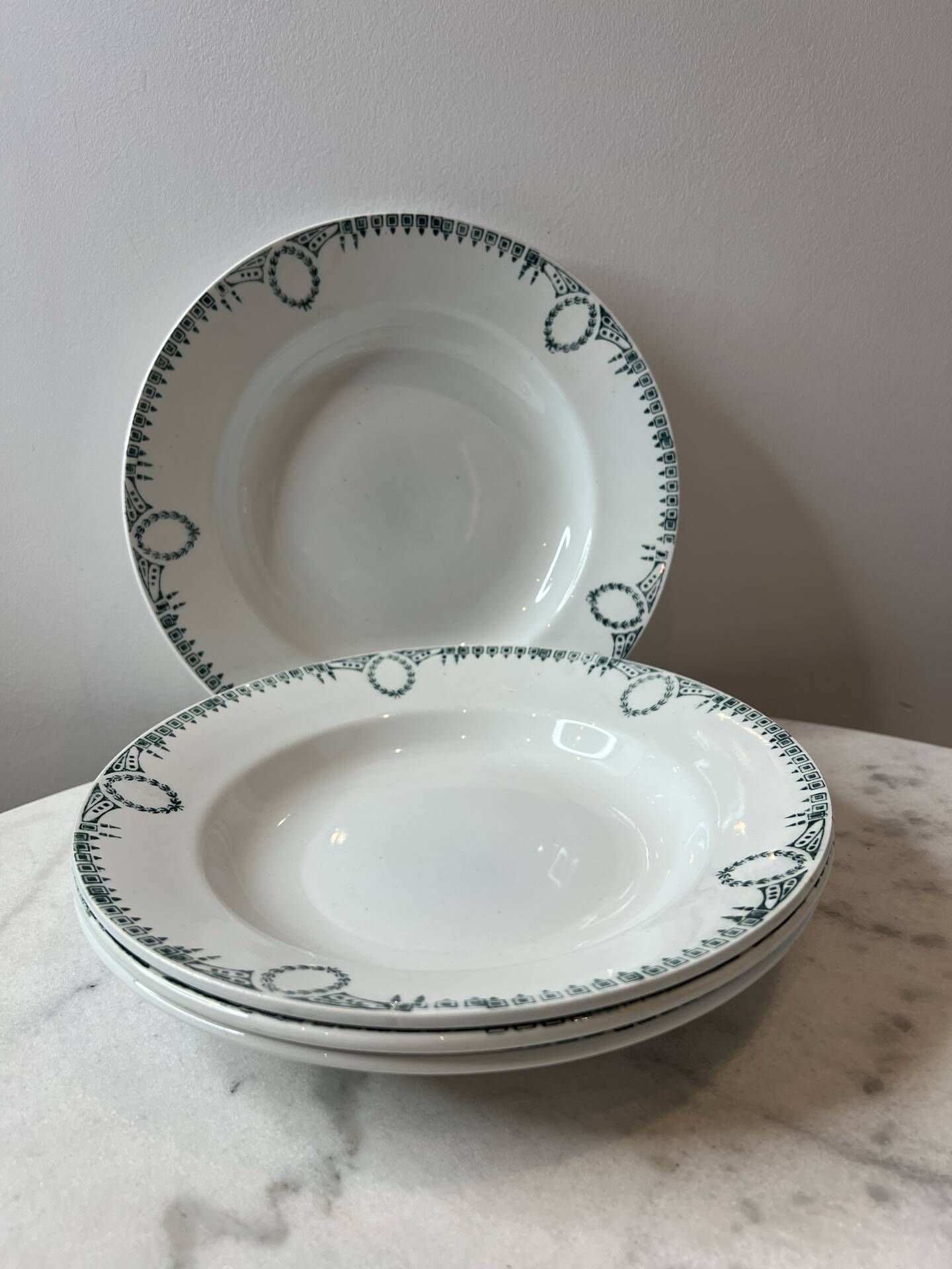 Set of 4 deep plates from Saint Amand with laurel wreath decoration.