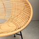 Round rattan lounge chair with black metal frame