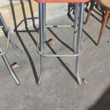 Pair of aluminum bar stools with orange and black seats