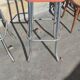 Pair of aluminum bar stools with orange and black seats