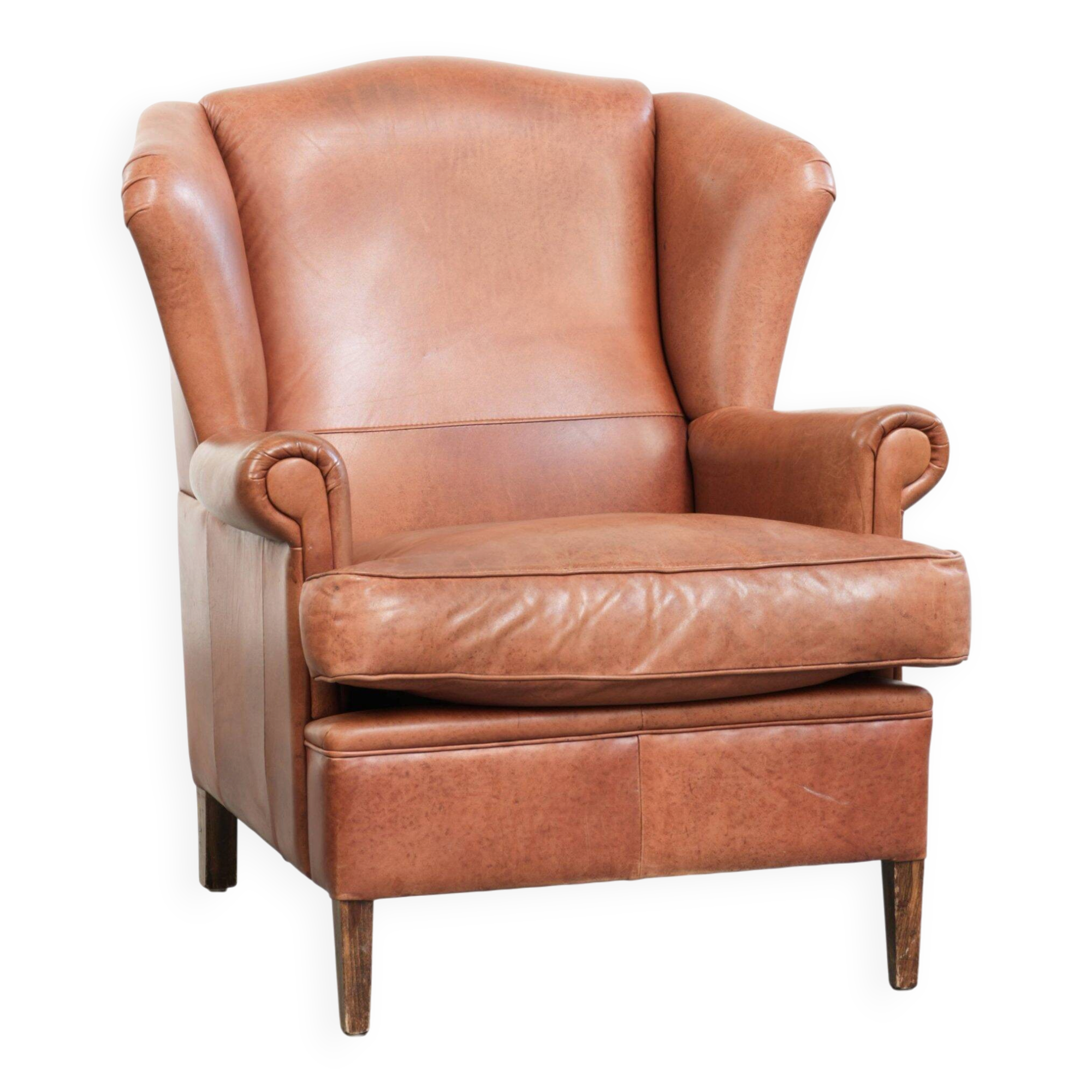 Light cognac-coloured cow leather wingback armchair with matching piping