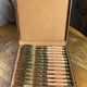 Dessert forks in brass and Bakelite in their case.