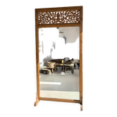 Very large freestanding teak mirror with an openwork carved pediment, Indonesia.