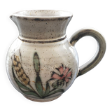 Signed pitcher with thistle decoration