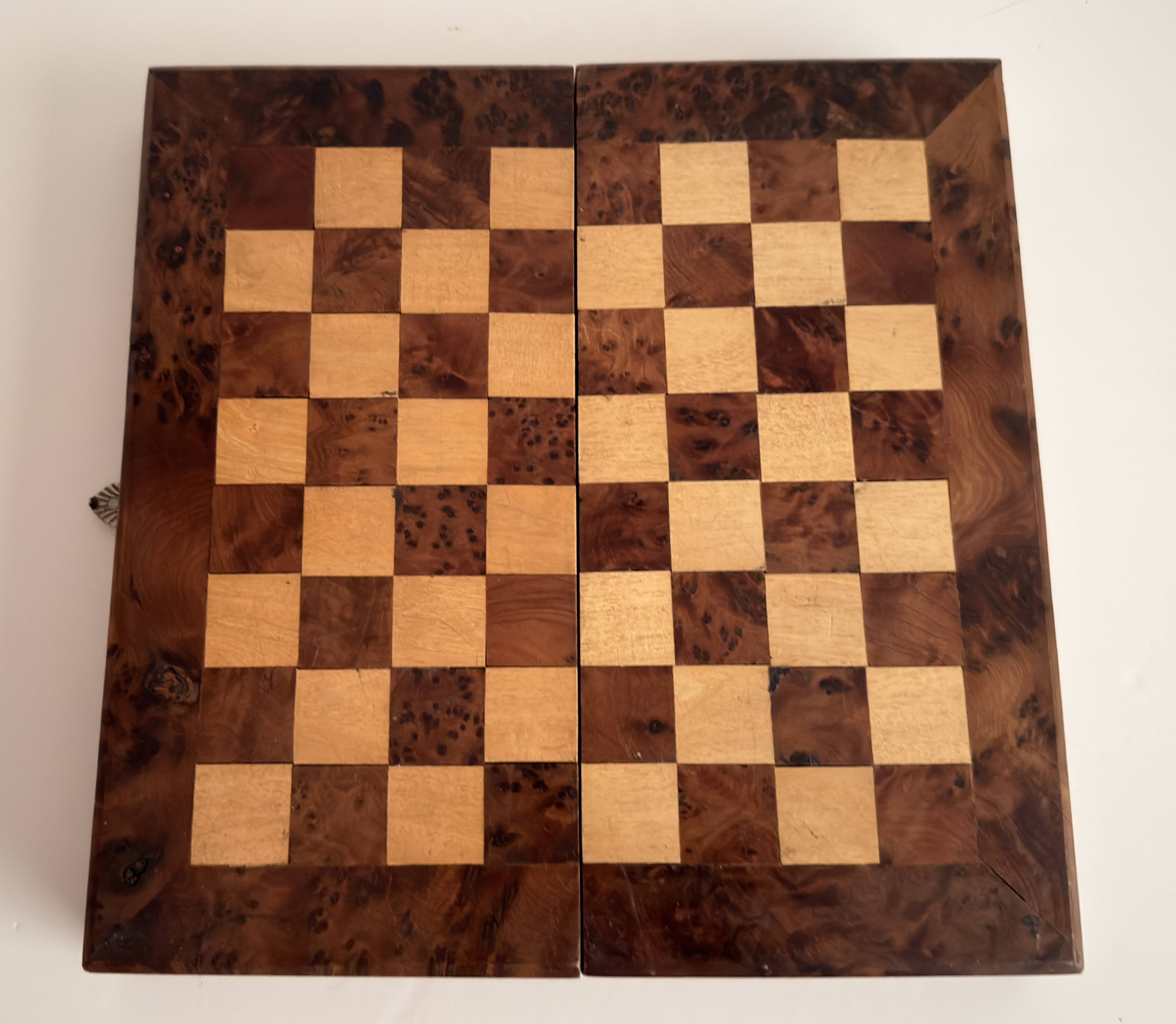 Old wooden chess set with a folding wooden box.