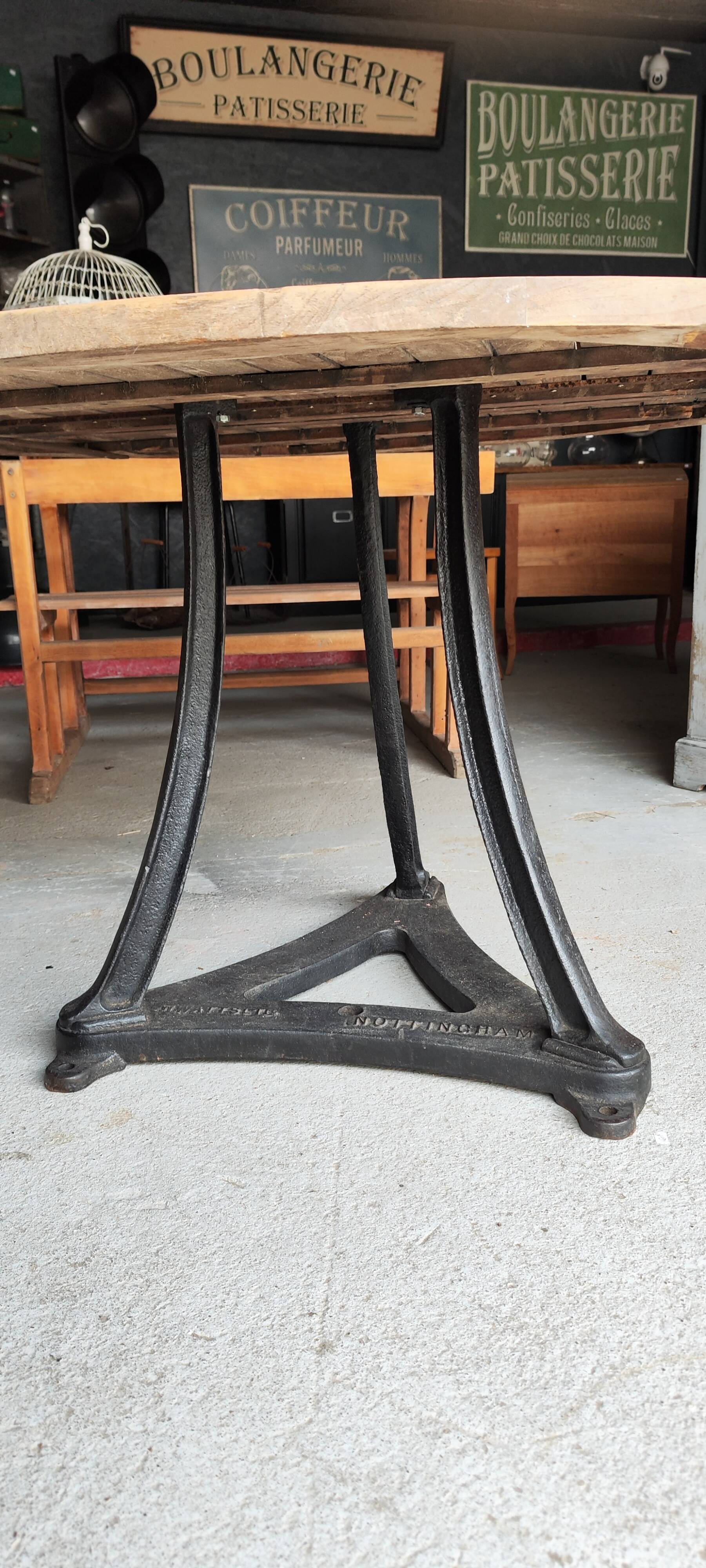 Industrial table with cast iron legs and teak top