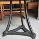 Industrial table with cast iron legs and teak top