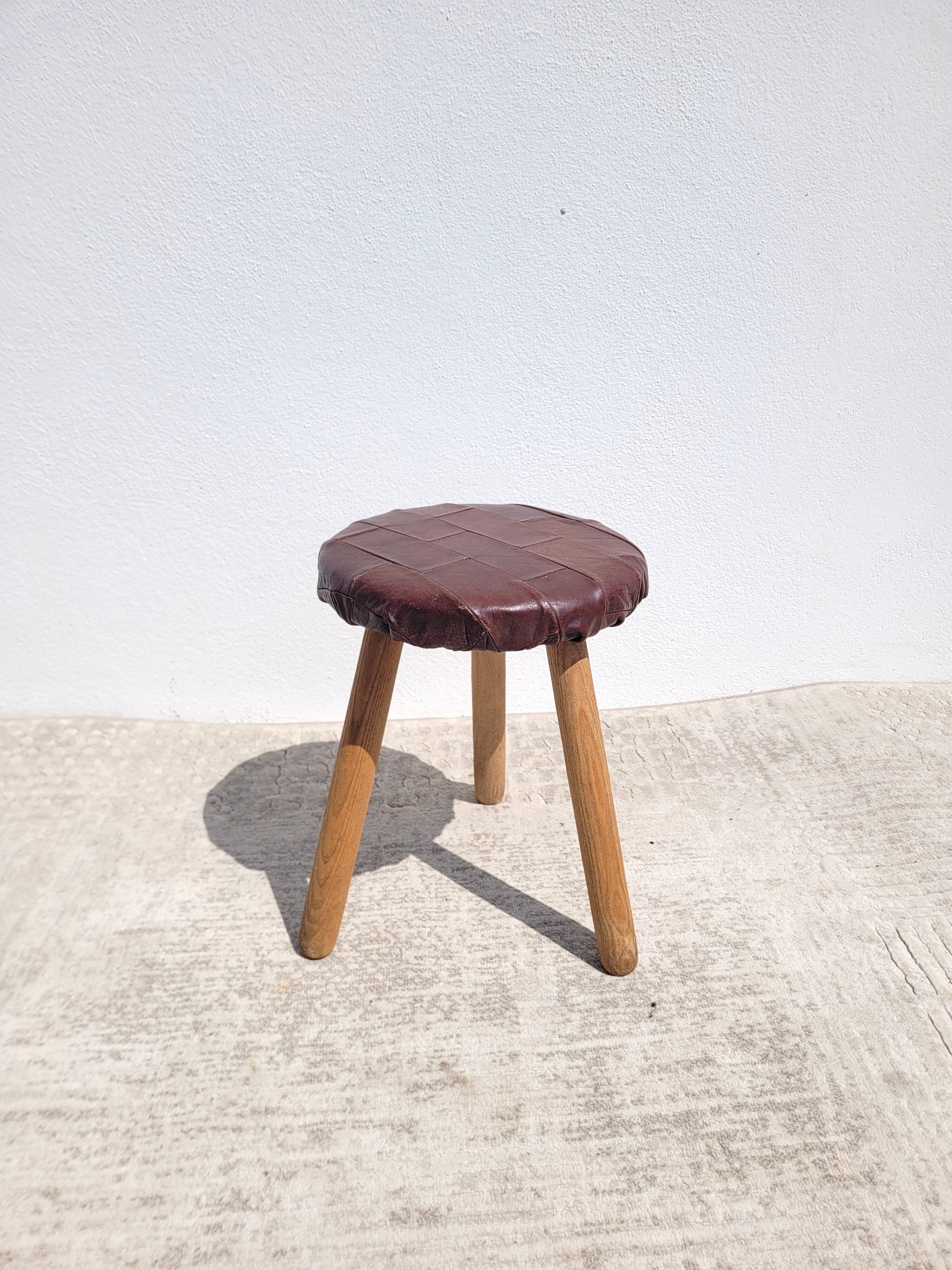 Leather-upholstered tripod stool