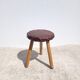 Leather-upholstered tripod stool