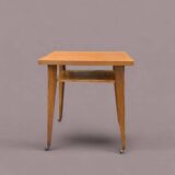 Varnished wooden trolley on wheels