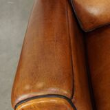 Set of 2 very comfortable large sheepskin armchairs elegantly finished with black piping