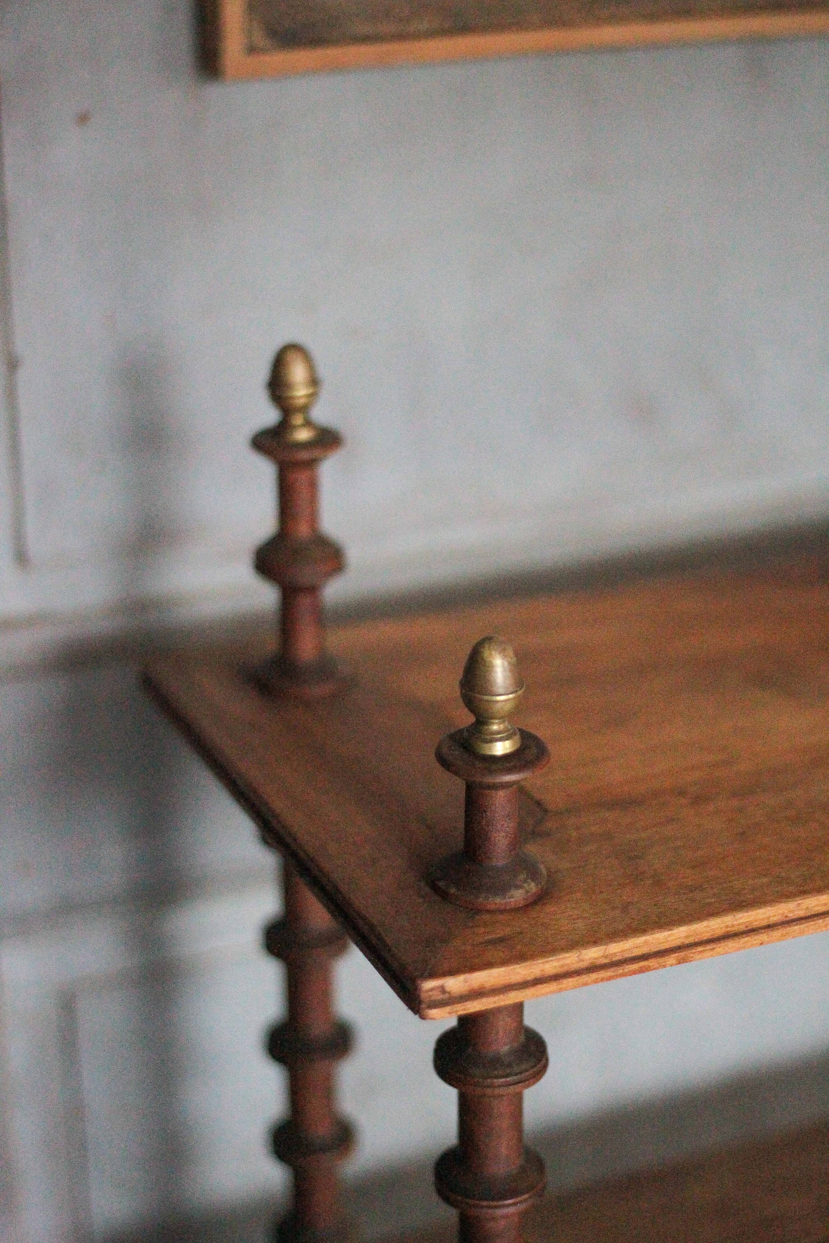 Napoleon III spool shelf, floor-standing shelf with brass tips.