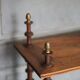 Napoleon III spool shelf, floor-standing shelf with brass tips.