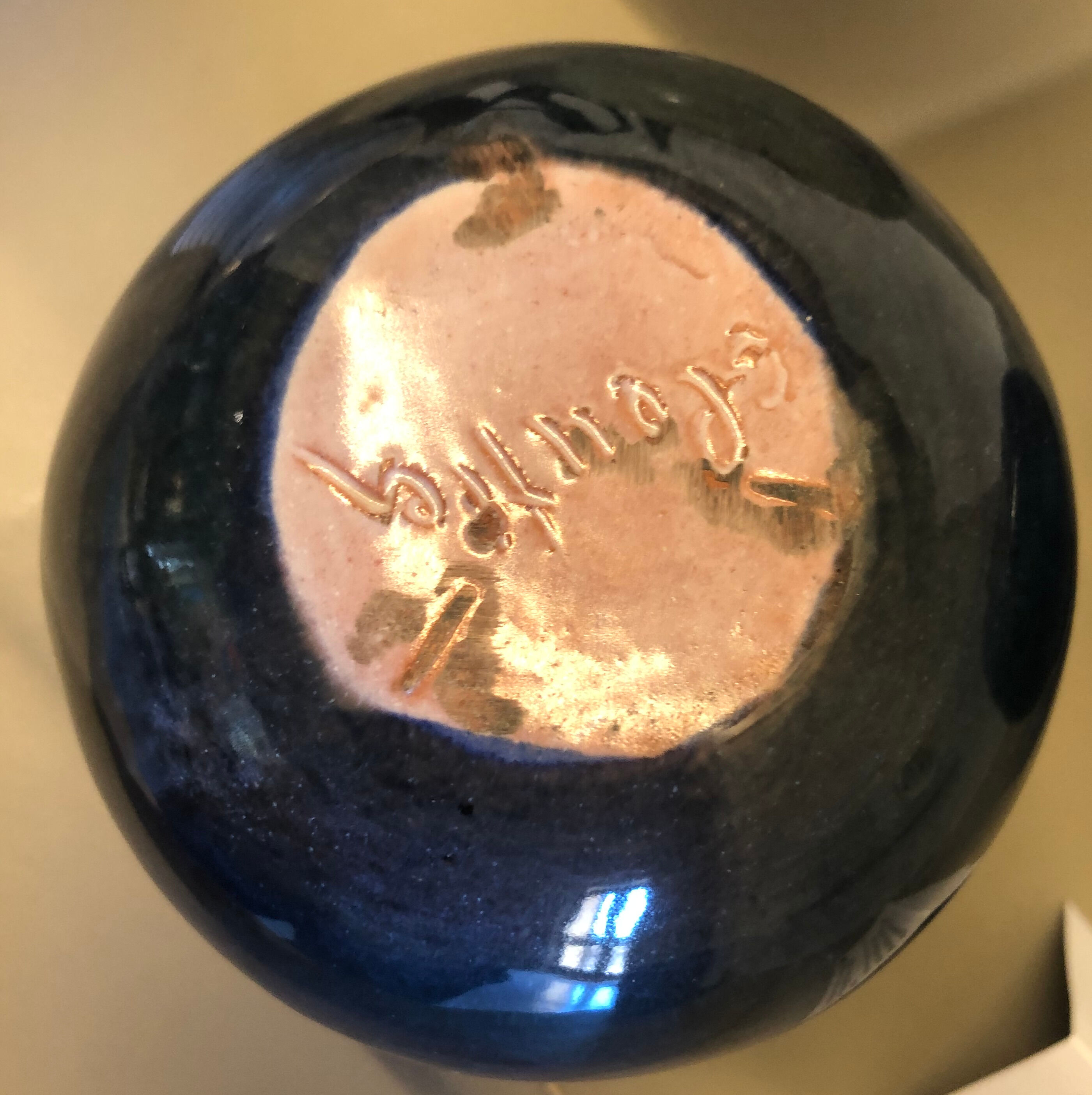 Blue rounded vase with floral details