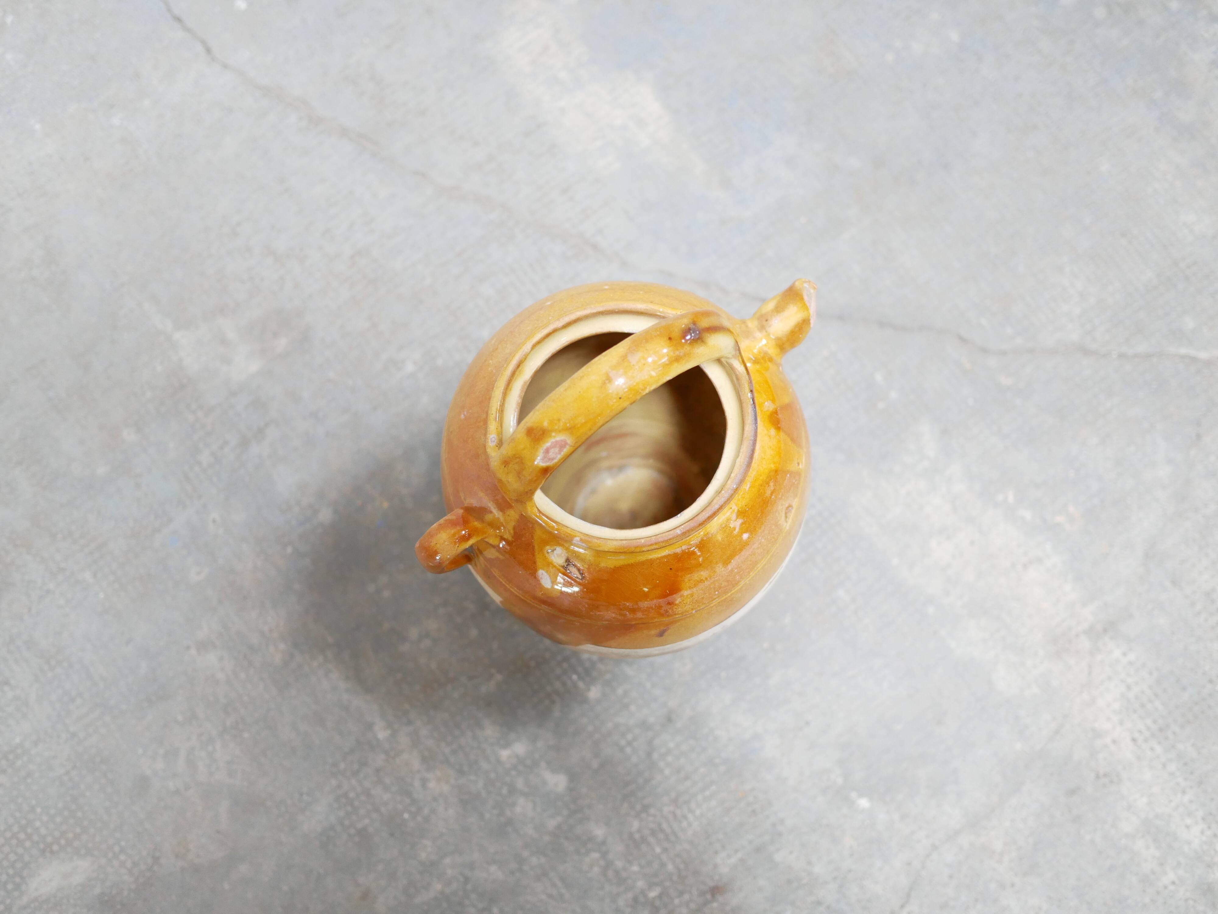 Old gargoulette pot in glazed terracotta