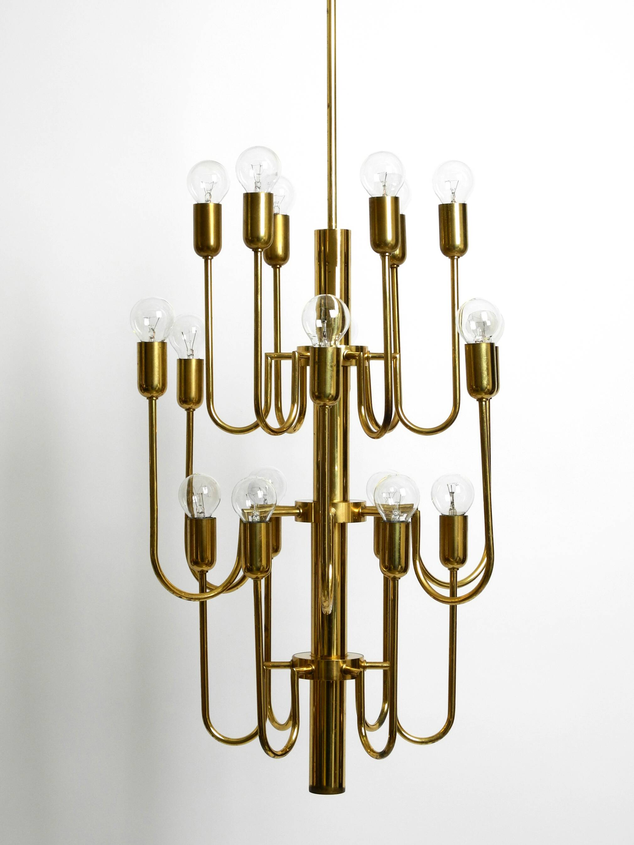 Three staged 18 arm Mid Century brass chandelier with a long brass rod