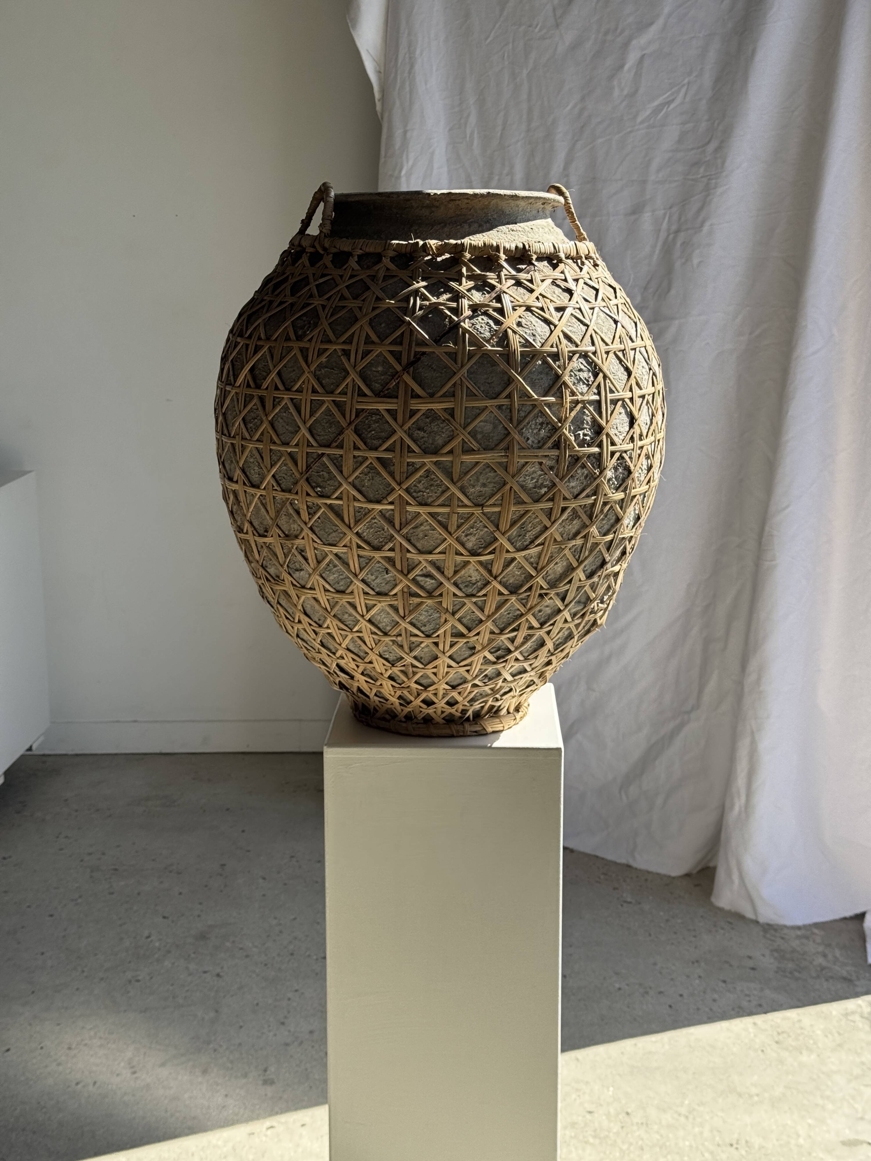 Immense light grey antique-style pot with a crosshatch lid and handles.