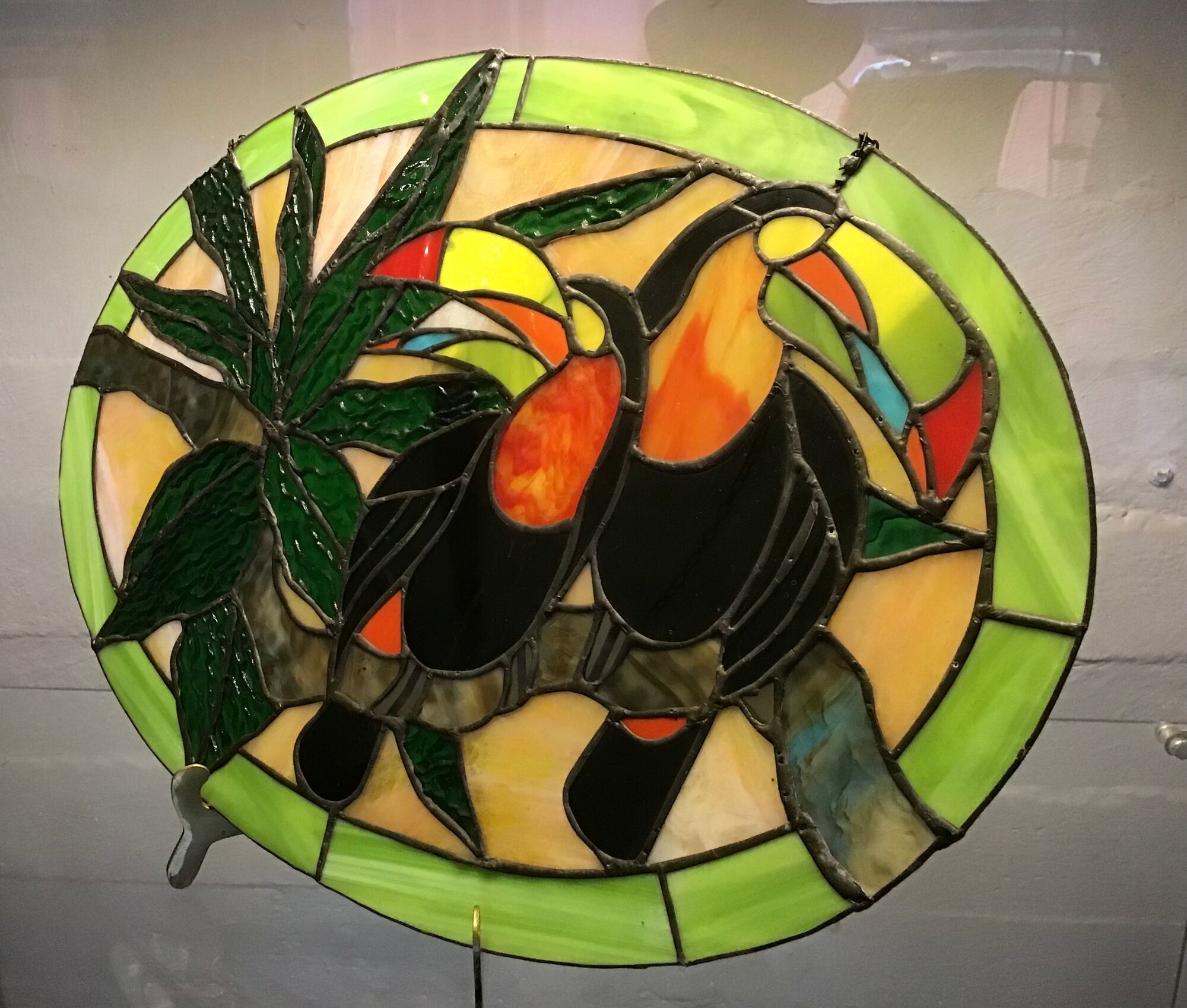 Art Deco style stained glass window representing a couple of toucans