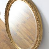 Beveled oval mirror and gilded wood frame