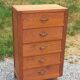 Vintage 1950s chest of drawers with tapered legs and 5 drawers.