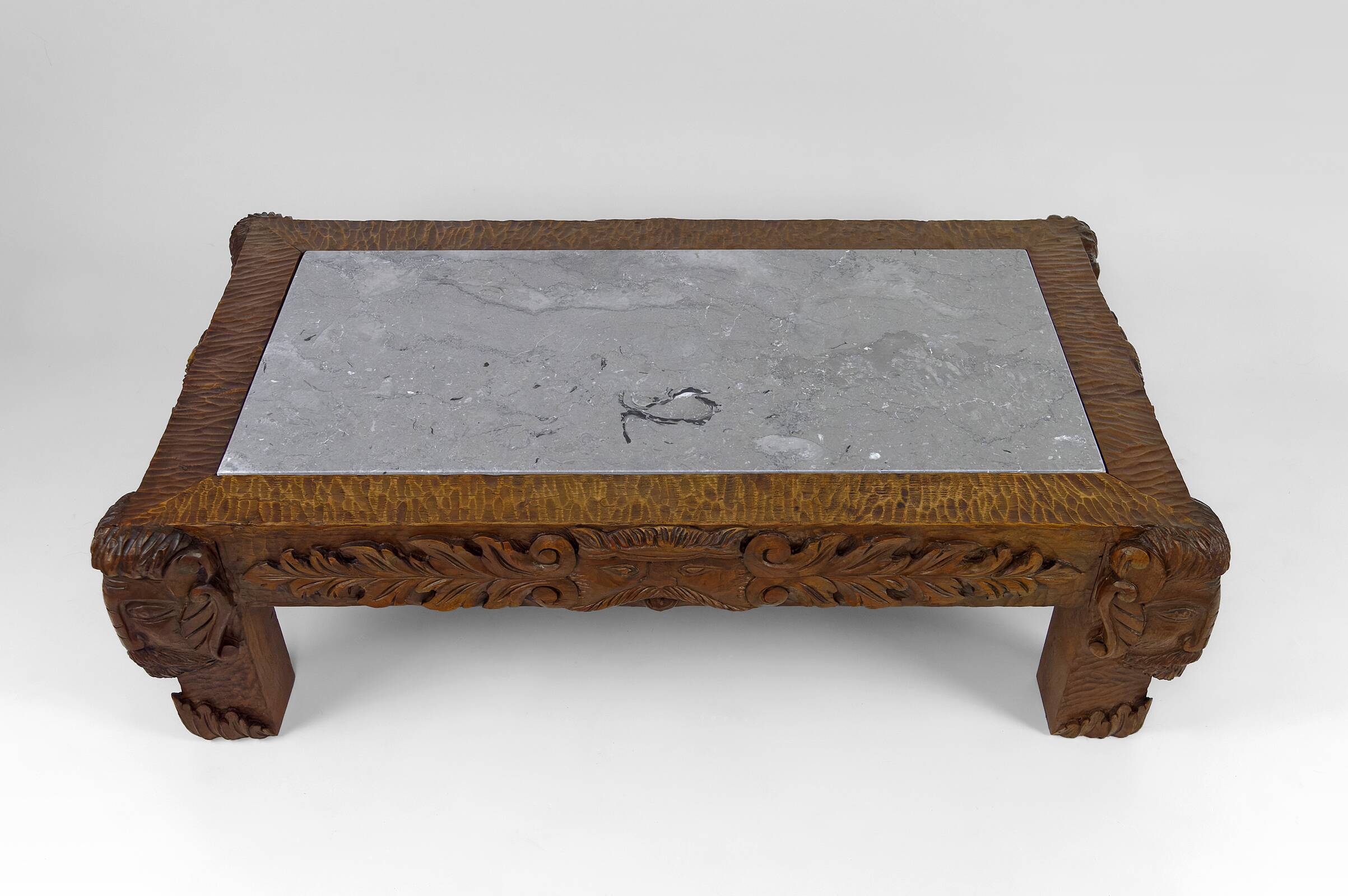 Solid oak coffee table carved with fauns and gray marble top, France, circa 1940