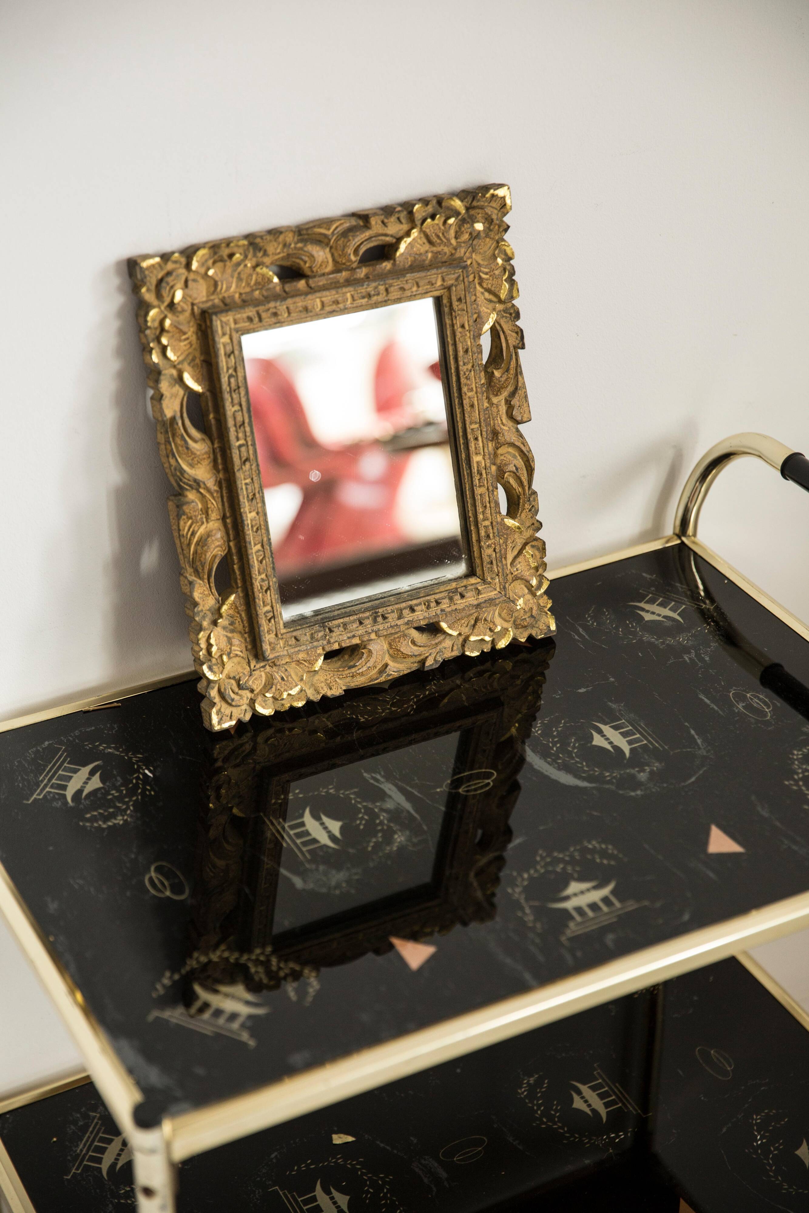 Decorative gold mirror mid-century in a wooden frame, Italy, 1960s.