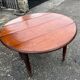 Antique round mahogany table, turned and fluted legs