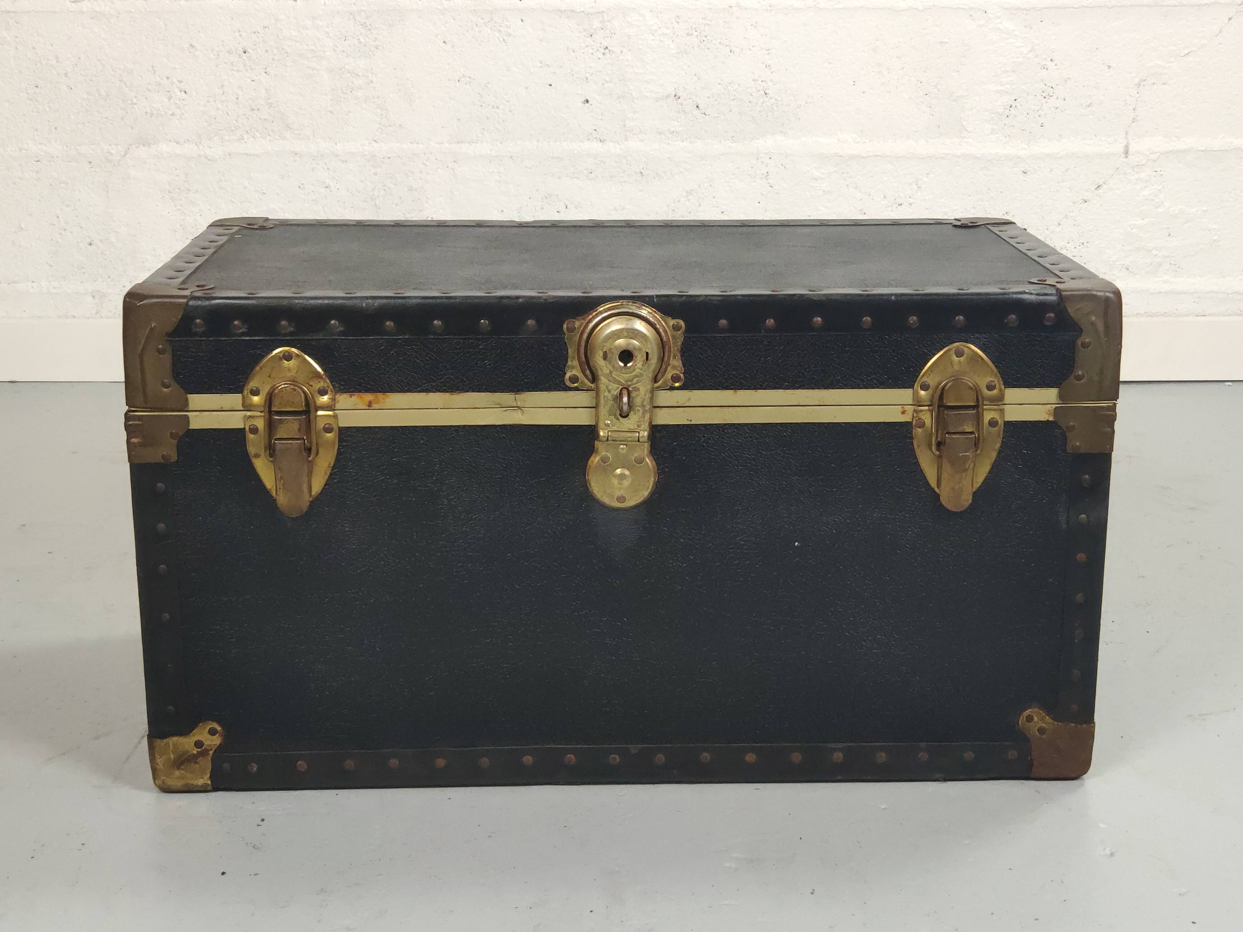 Old black trunk and brass