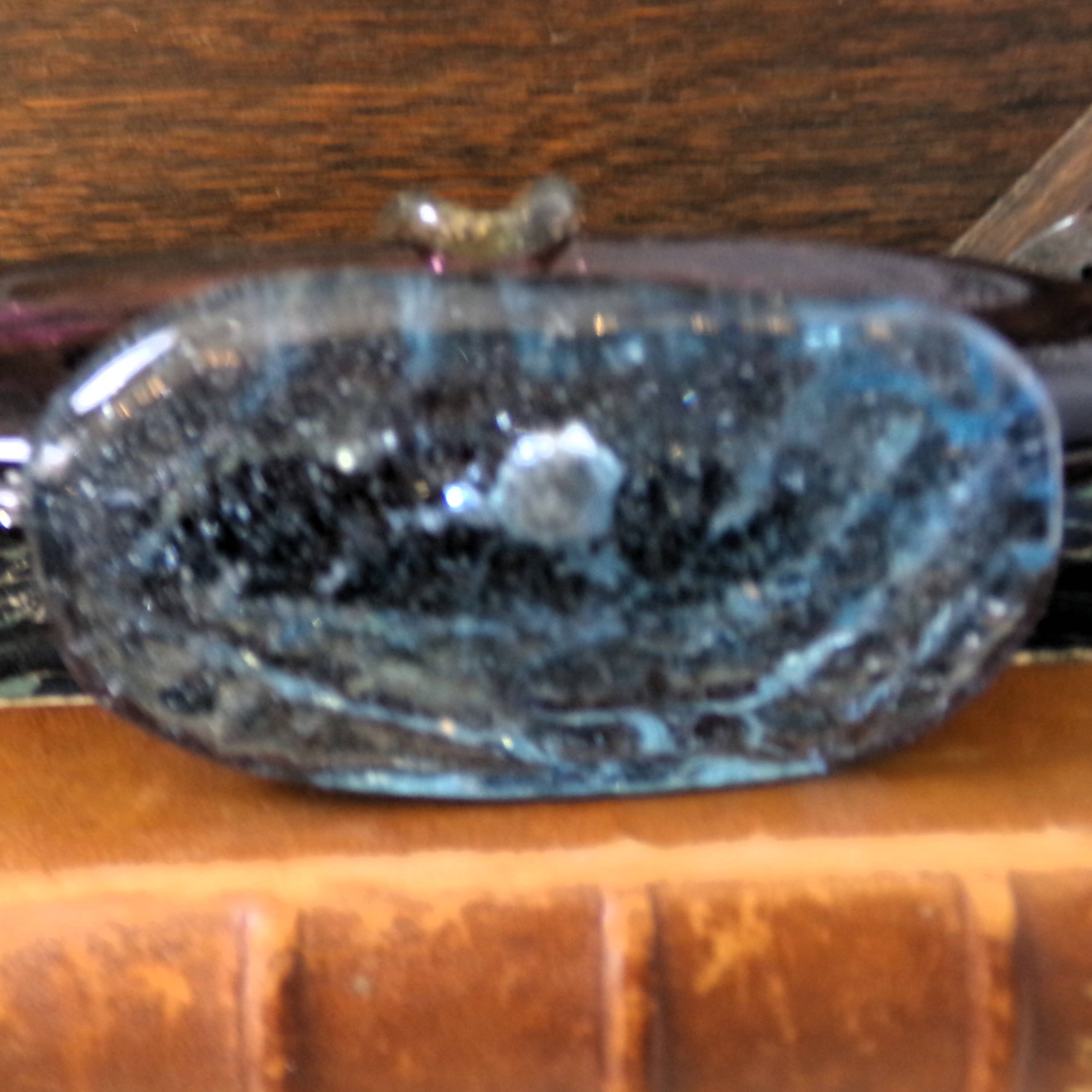 Murano glass gondola placed on a blue water-effect glass base