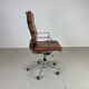 Fauteuil en cuir brun haut dossier soft pad group Eames ICF pour Herman Miller