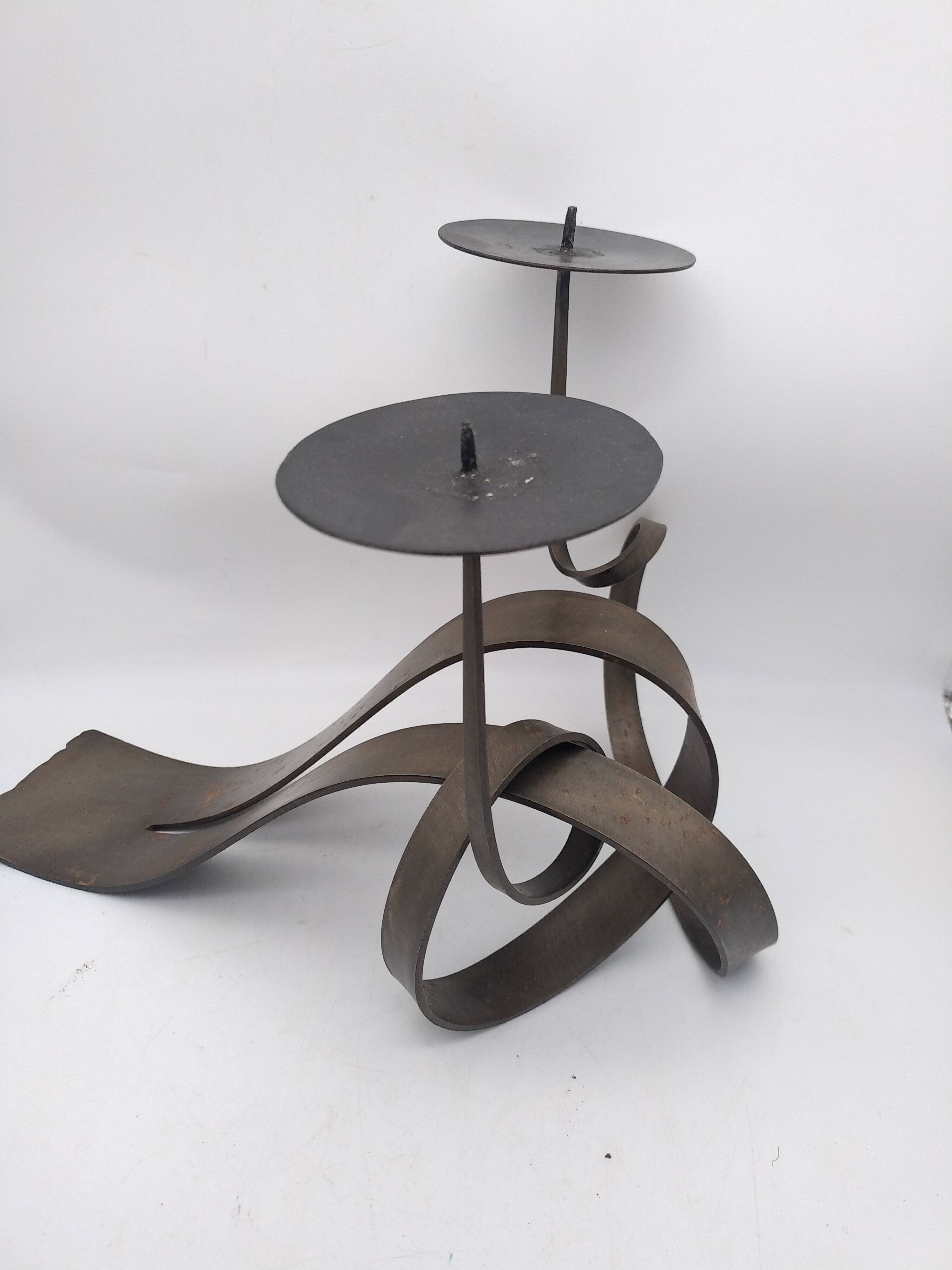 Brutalist candle holder in bronze effect metal.