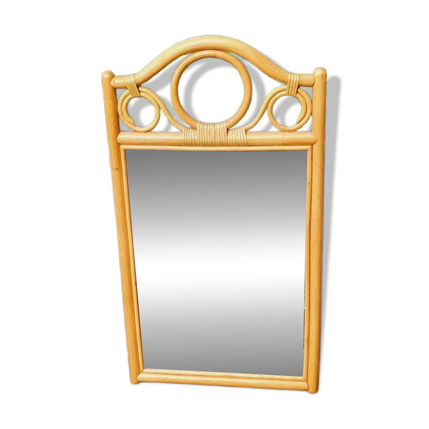 Curved wooden mirror and rattan