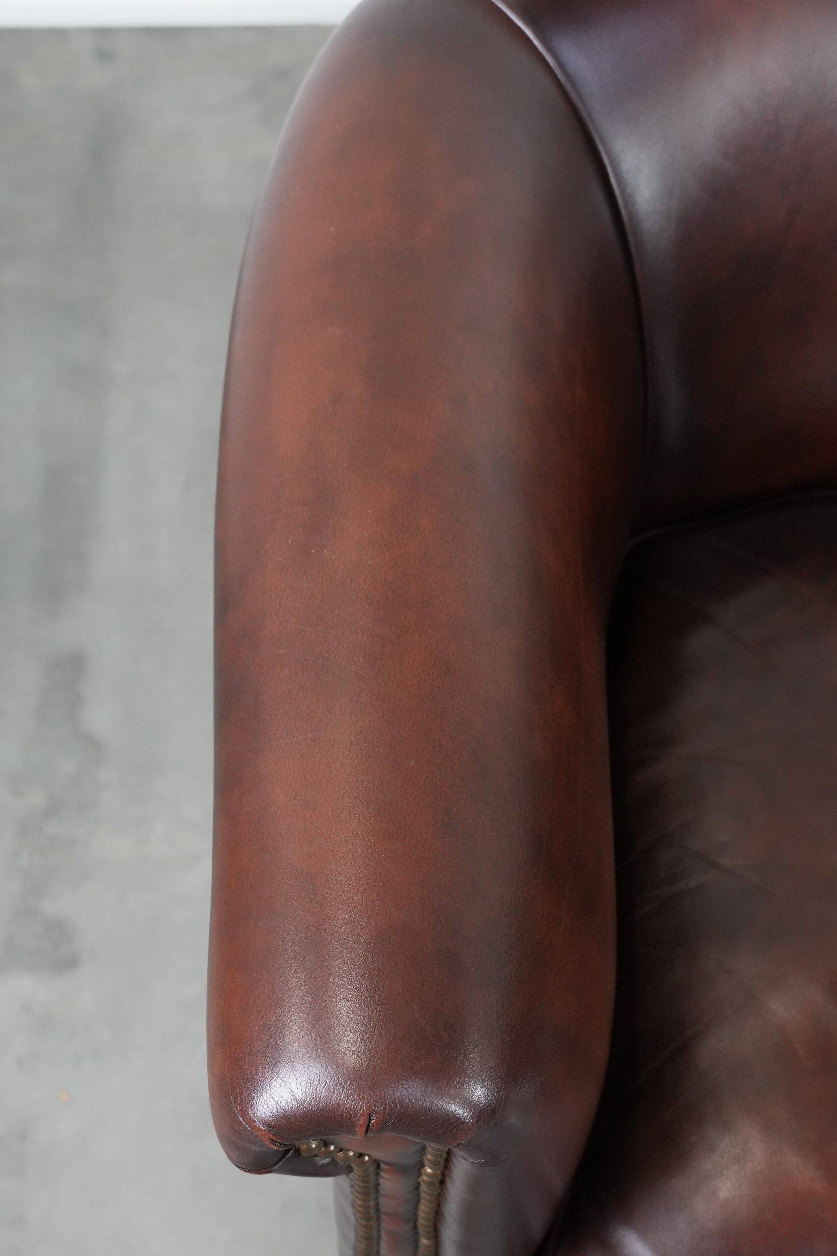 Set of two cow leather club armchairs in a luxurious red/brown colour