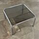 Table basse design vintage en verre fumé avec structure tubulaire