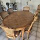 Oval cherry wood table made by a cabinetmaker, with 3 extensions and 8 chairs.
