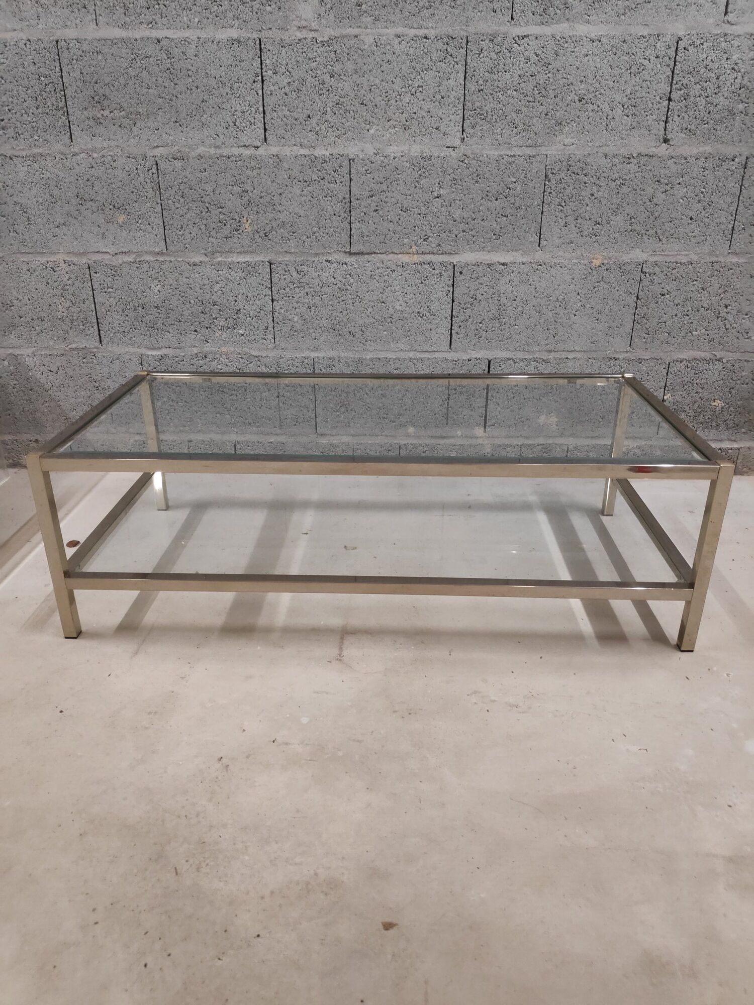 Vintage bevelled glass coffee table and lightly gilded square metal tubes from the 70s/80s