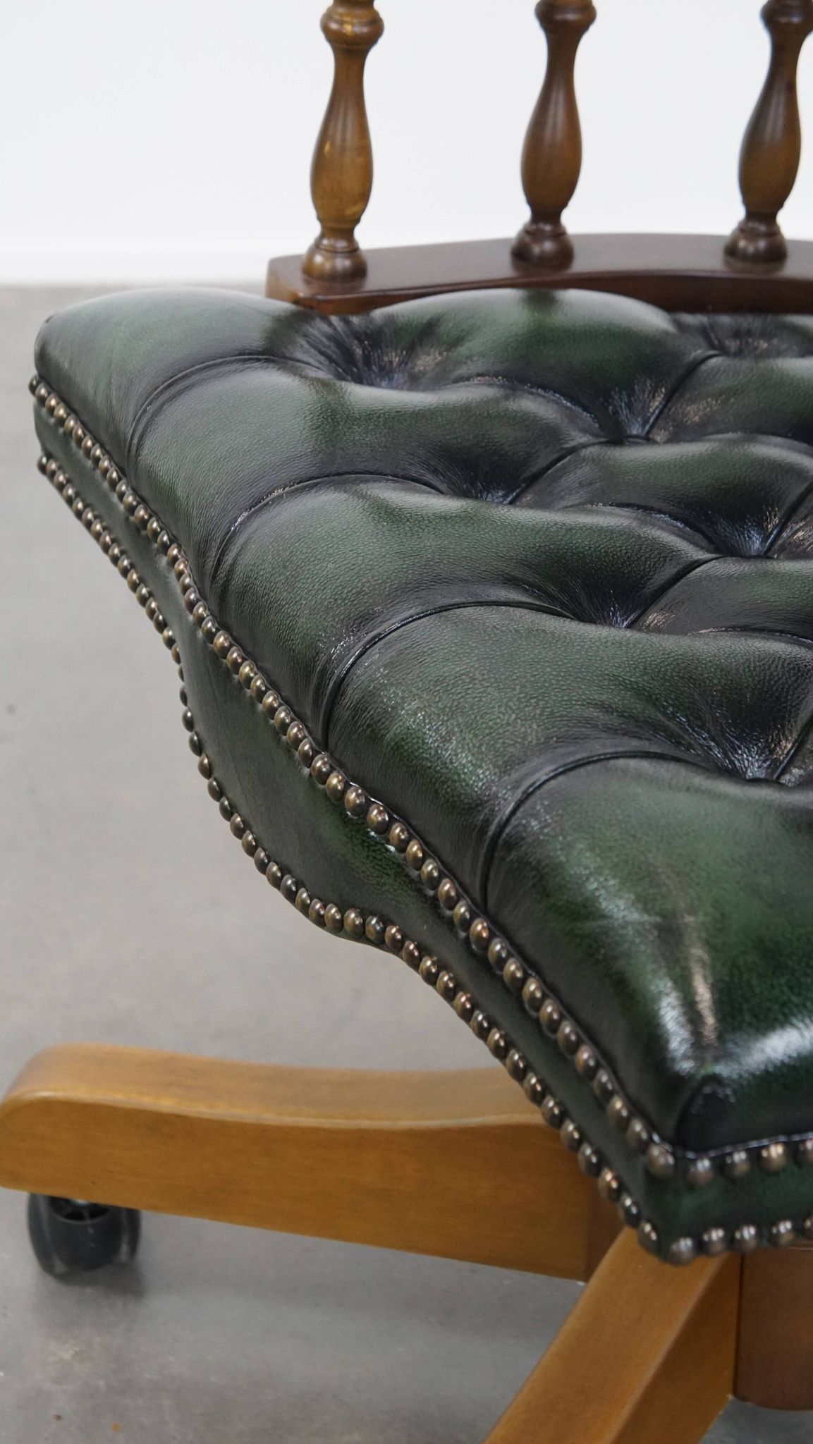 Dark green cowhide leather and wood chesterfield office chair on wheels