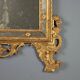 Antique gilded wooden mirror with rococo patterns, Italy, 18th century.