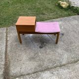 Mid-Century telephone bench in teak with bright pink fabric seat and wooden top.