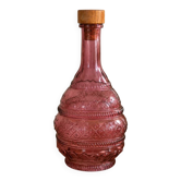 Vintage pink pressed glass carafe – retro decorative bottle with wooden stopper.