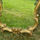 Beveled gilded wood mirror with violin shapes, Louis XV baroque style shell