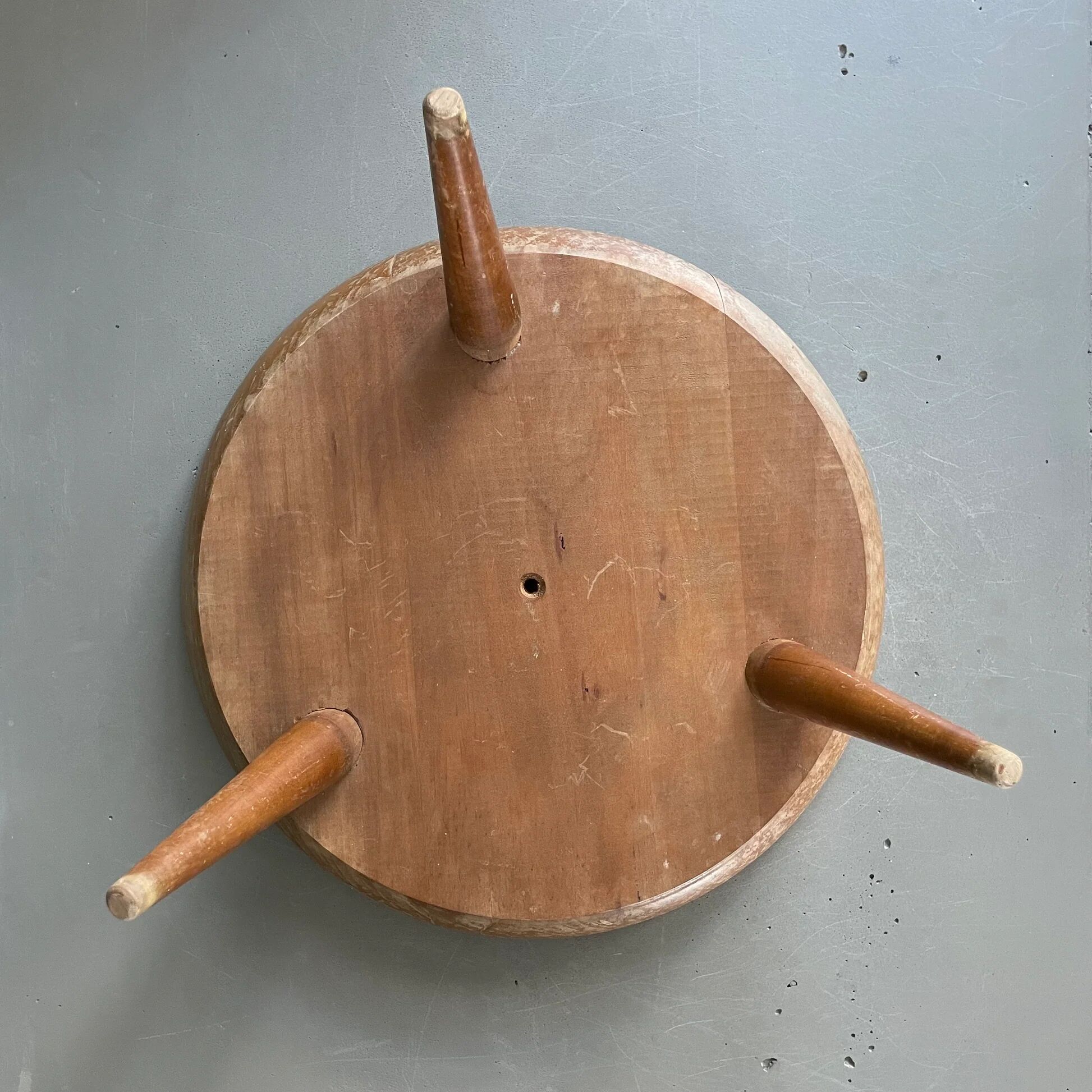 Wooden and red plastic compasses plant stand.